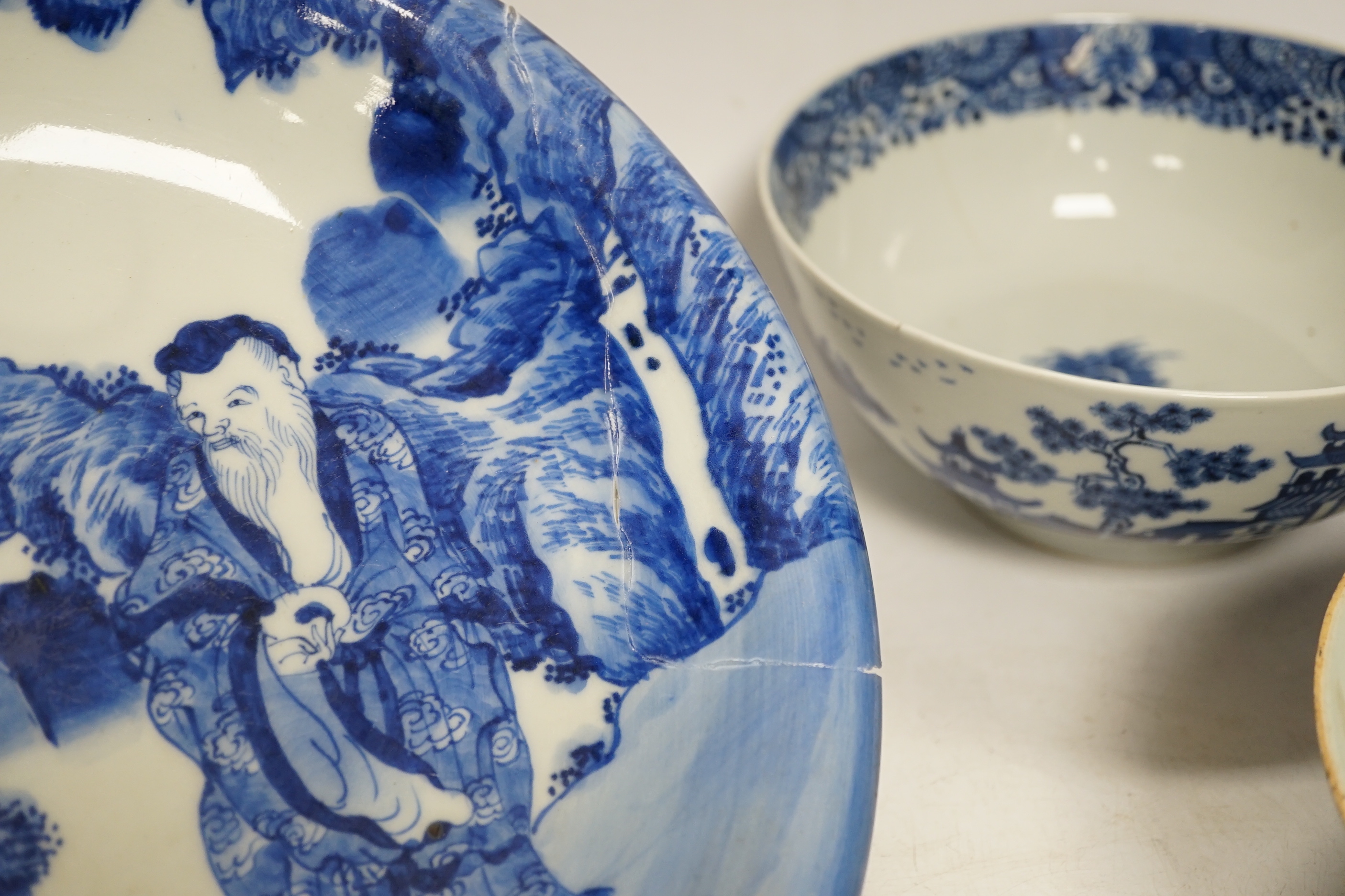 Assorted Chinese and Japanese ceramics comprising a famille rose bowl, two blue and white plates and a blue and white bowl, largest 30cm in diameter